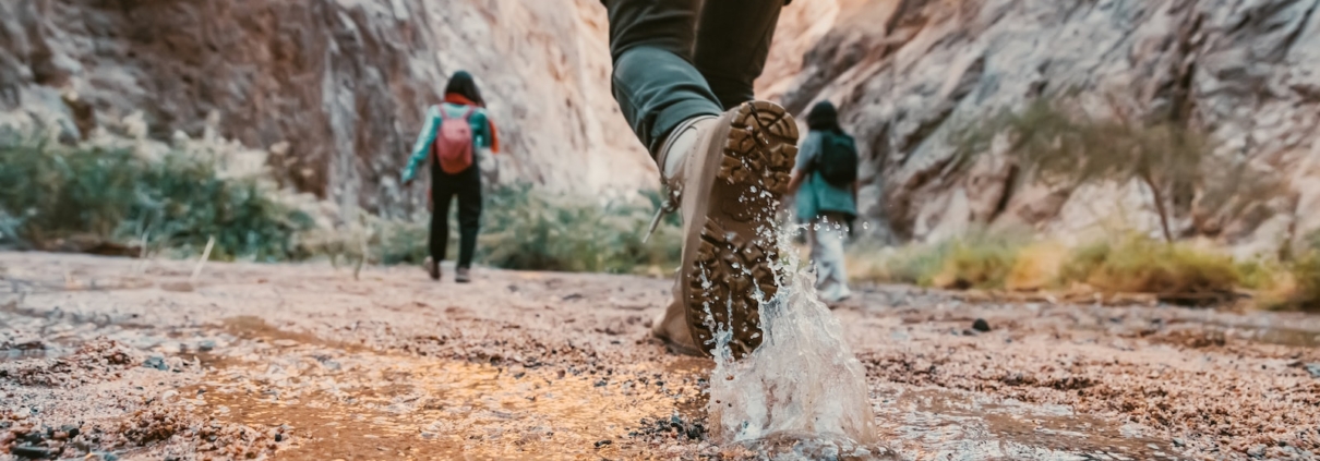 a couple of people that are walking in the dirt